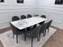 Black Clara dining table set by Q&P Furniture with four matching chairs, modern design with sleek black finish.