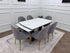 Clara dining table set by Q&P Furniture featuring a gold finish, with a sleek rectangular table and matching chairs.