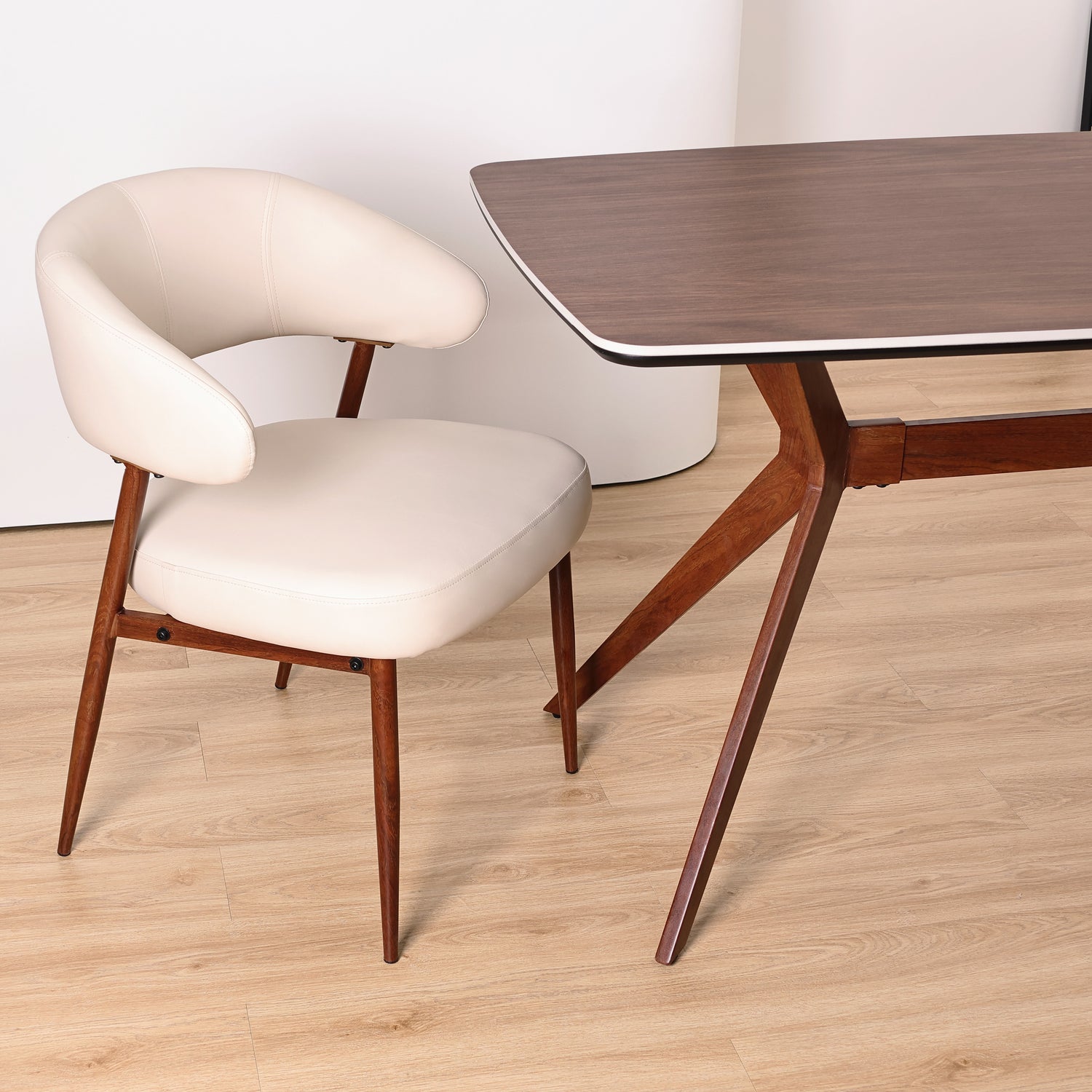 Q&amp;P Furniture Zino beige dining table with sleek wooden surface and modern design, shown from a close-up perspective.