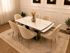 Q&P Furniture Clara dining table set in gold with matching chairs, showcasing a modern dining room arrangement.