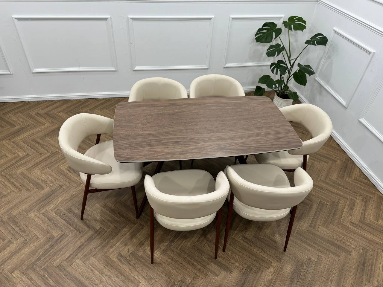 Q&amp;P Furniture Zino beige dining table with sleek design, shown in a modern dining room setting.